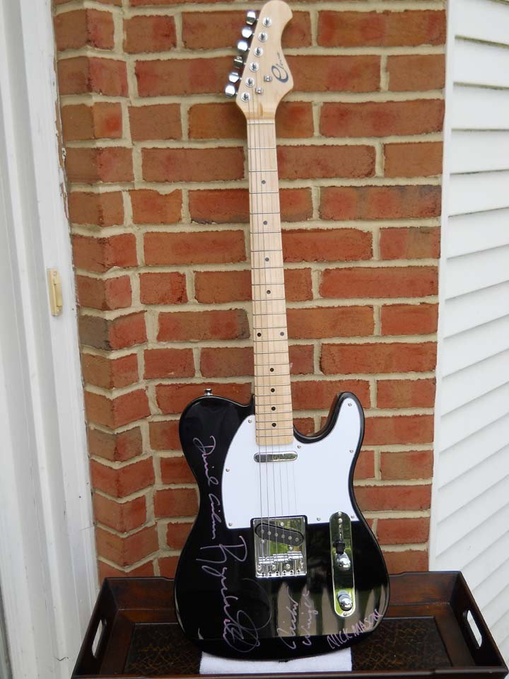 Pink Floyd Signed Black Eleca Guitar: A black Eleca guitar signed by Roger Waters, David Gilmour, Nick Mason, and Richard Wright , the four remaining original band members. Comes with a certificate of authenticity.