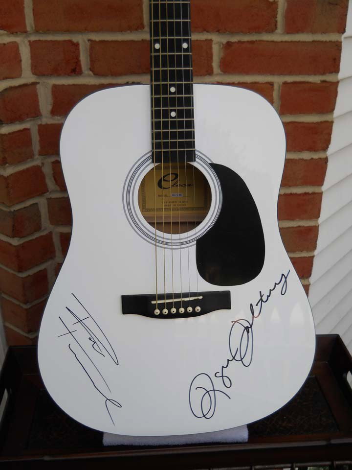 The Who's Daltry and Townsend Signed White Acoust: A white acoustic guitar signed by Roger Daltry and Peter Townsend in 2005.