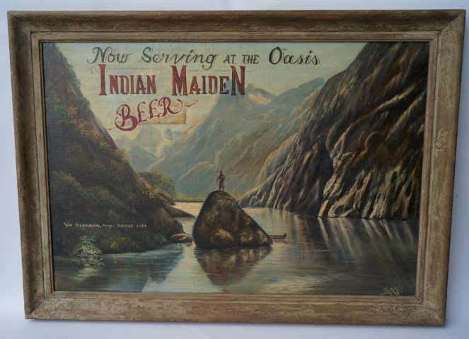 Indian Maiden Beer Advertising Sign: Oil on canvas. Now Serving at the Oasis, Indian Maiden Beer. Wm. Tilghman, Prop. Dodge City. Signed L. R. J. R. Mass. Framed. 26"H. x 38"W.
