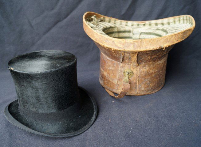 Beaver Top Hat in a Leather Case: Made by Honi Soit Quimaly Pense, label at the inside.