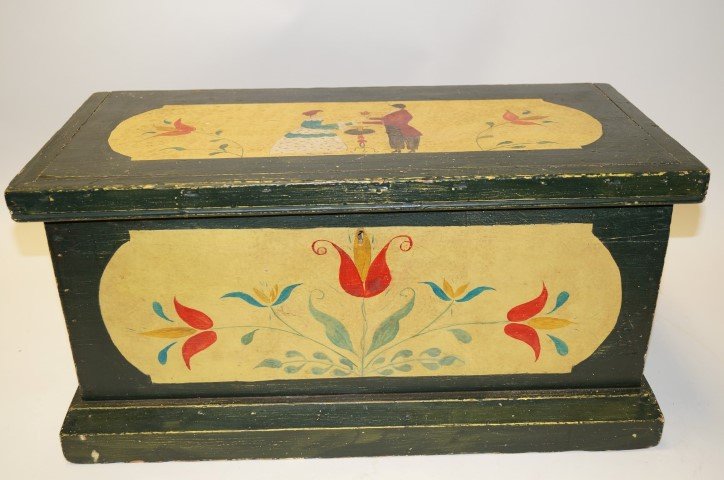 Pennsylvania Dutch Painted Fraktur Style Trunk: Small trunk, green paint with yelow. Top is decorated with gentleman giving his lady a flower.Red flowers on front. Iron handles at sides; 13in. H. x 25.5in. W. 12.75in. D.