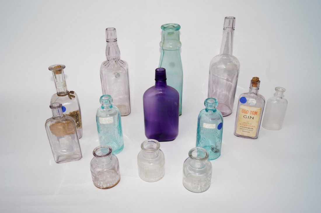 Bottle Lot (13): Thirteen miscellaneous bottles including a rare Cathedral Pickle jar; two sun purple Tombstone whiskey bottles; a sun purple Reichart's Cologne bottle with partial label; an Old Tom Gin bottle with la