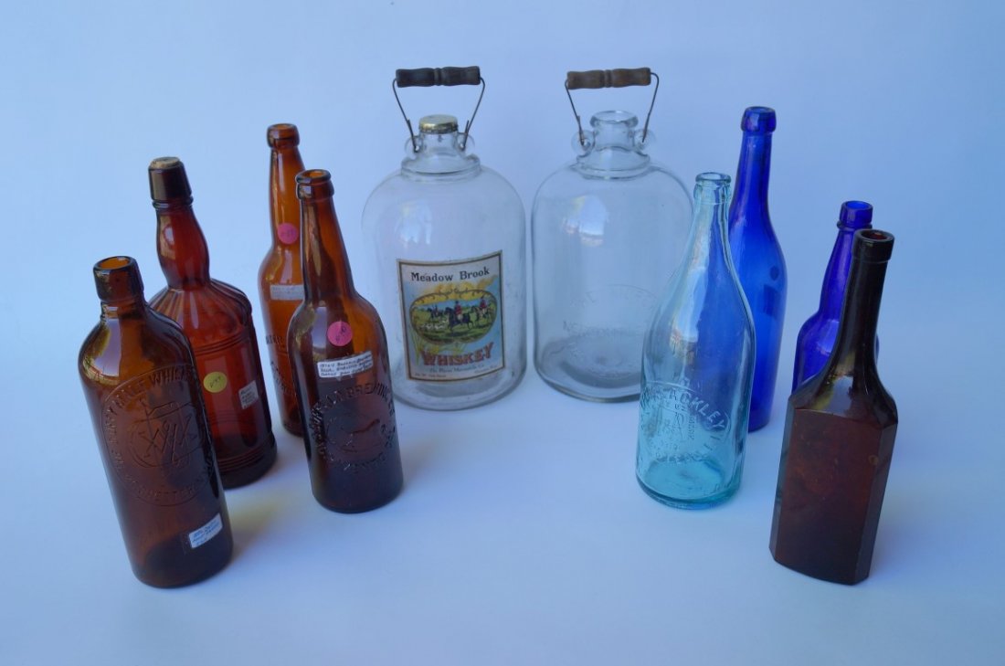 Lot of 10 Whiskey Bottles: Two one gallon Morey Mercantile bottles, Denver. Col.; Walter Raupfer, Columbia City, Ind.; Buffalo Brewing Sacramento Cal.; Frederick Stearns, Detroit, Mich.; Duffy Malt Whiskey Co., Rochester, NY.; 