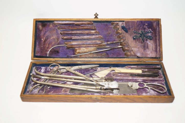 U.S. Army Surgeon's Kit: Tools in a fitted wooden box. Faded name plaque at the top of the box. 17 1/2" x 5 3/4" x 2 1/2".