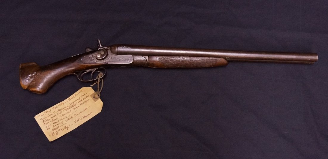 Cut Down T. Barker 12 Gauge Shotgun: With tag. The 3rd of Feb. 1889. Took (sic) from William Tuckerman, Highway man, Stage and Rail (Decease) sic. One each=cut down, T. Barker 12 gauge shotgun and head mask... at area of Utah Badlands. S