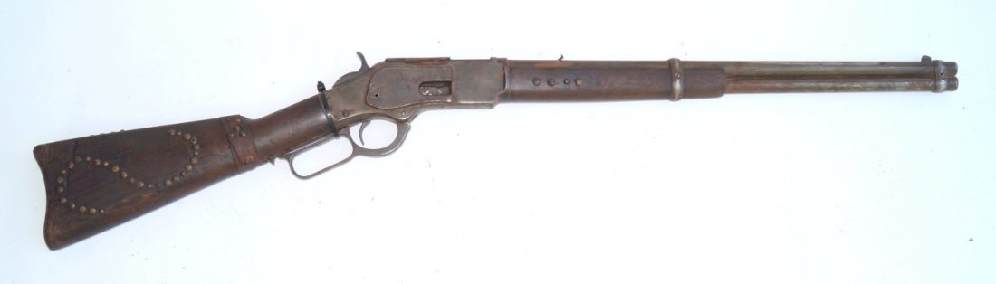 Winchester 1873 Saddle Ring Carbine: 38 W.C.F. calibre. Saddle ring carbine Non operating. Loading gate missing. Poor finish overall. Rear sight missing. Brass tacks throughout buttstock and fore end.
