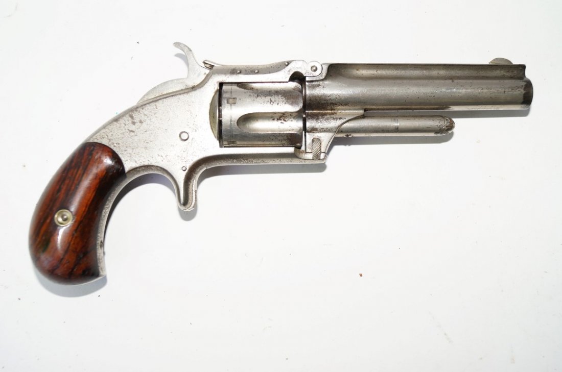 Smith and Wesson 1 1/2 Revolver: Smith and Wesson 1 1/2 revolver. 3 1/2" barrel . Nickel plate. 32 rim fire long calibre. grips. Marked W F & Co. 67151 on the barre.