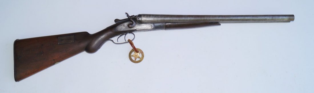 E. C. Green 10 Gauge Coach Gun: Double barrel. Large chip out of stock at trigger guard. Damascus barrels. Marked Property of Dickinson City on stock and with a brass plate reading Sheriff's Office, Abilene,Kansas