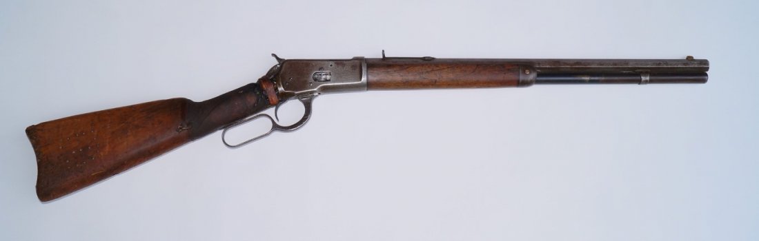 Winchester 1892 Rifle: 44 W. C. F. calibre. 20" octagonal barrel. Fore hand cap. Made in 1894. Owned by Oputo, Chiricahua Apache who rode with Tso-Ay , Apache War Chief. Whirligig log designs all around buttplate and runnin