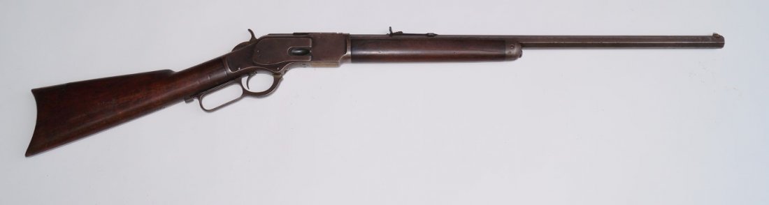 Winchester 1873 Rifle: 24 " octagonal barrel . 38 W. C. F. Button magazine. Third Model. Engraved on receiver "Thalis T. Cook Texas Rangers" Very good condition