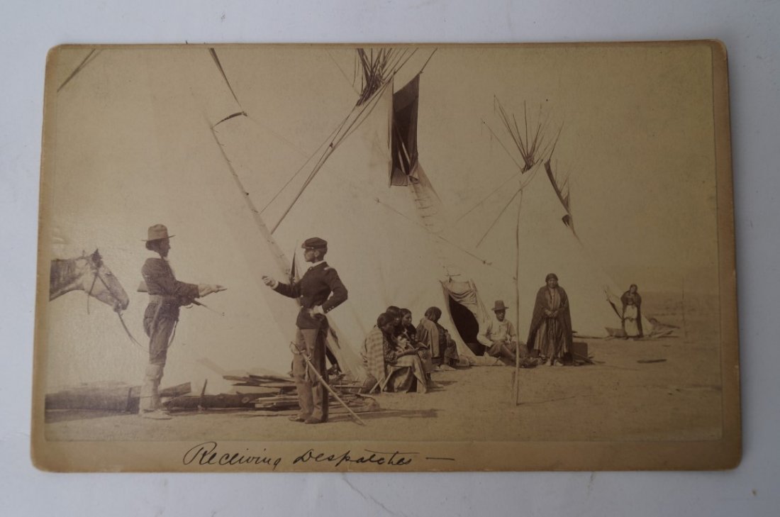 Cheyenne Warrior-U.S.Scout Photograph: A Cheyenne Warrior recruited into a U.S.Scout carrying a carbine in one hand and delivering a dispatch in another with Tepees in the background