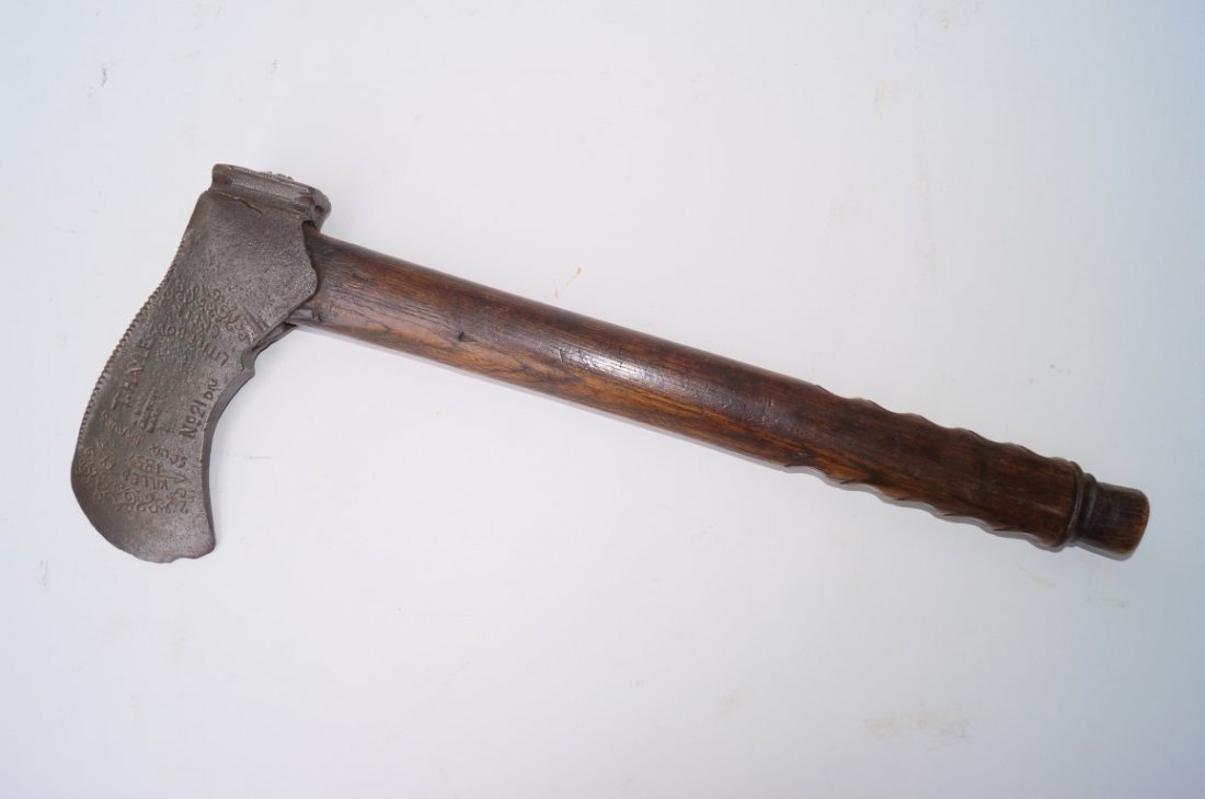 T. Hayle No 21 Div. Tomahawk: Wooden handle with finger grip notches. Blade is engraved Killed by Sioux Braves Little Bow Creek 1857. Back of blade is engraved with teepee and other Indian decoratons.