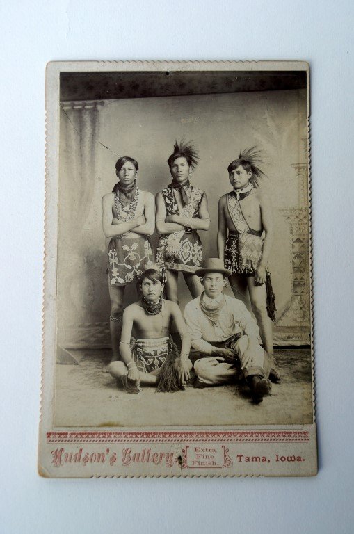 Unusual Photograph Hudson's Iowa: Group photograph, Hudson's Gallery, Tama, Iowa marked at the back Sac & Fox of Iowa and stamped Arthur M. Tinker. Cabinet card. 4" x 5 1/2" on a slightly larger card mount.