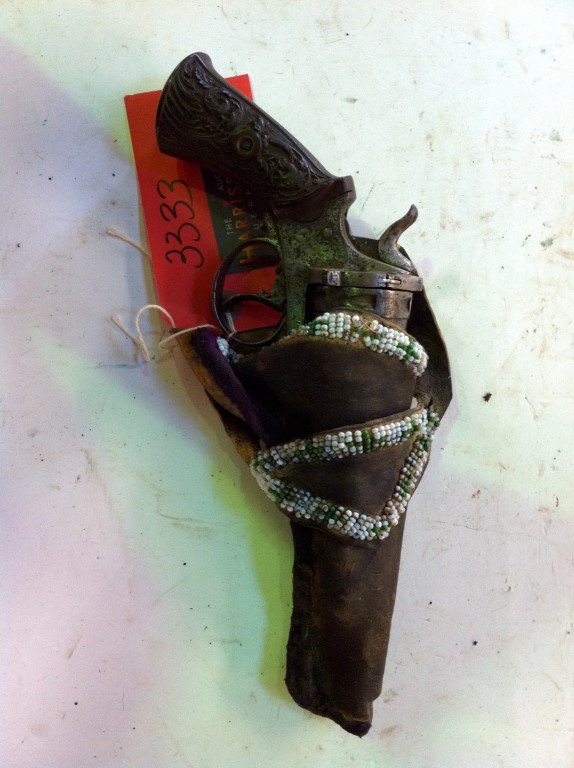 Double Action Revolver 38 Calibre: Six shot cylinder. 4 3./4" barrel. Engraved with carved hard rubber grips. Beaded holster