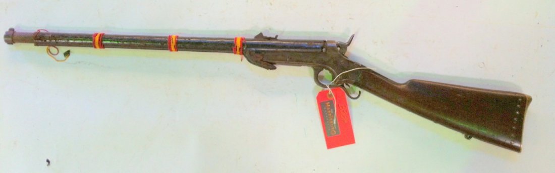 Sharps & Hankins Model 1861 Navy Rifle: 52 calibre rimfire breech loader Barrel has been dressed in leather with ornamental beadwork replacing the barrel bands. Forestock missing. Adjustable rear site. Stock chipped on both sides of tang. T