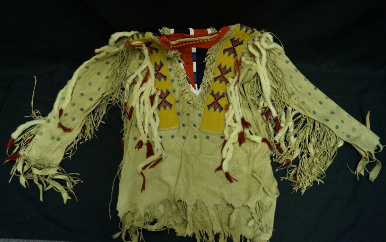 Pair of Black Feet Beaded Hide Chaps & Jacket: Beaded decorations with rabbit fur embellishments. Stamped and painted decorations. 36' L.