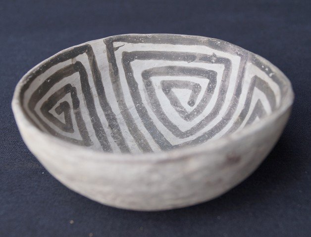 McElmo Black on White Bowl C. 1050-1125: Location: Four Corners Area. C. 1050-1125 AD/Anasazi. Very fine pre-historic Indian bowl from the Southwestern US. There has been minor over paint on a somewhat abraded interior bottom. Maze-like geom