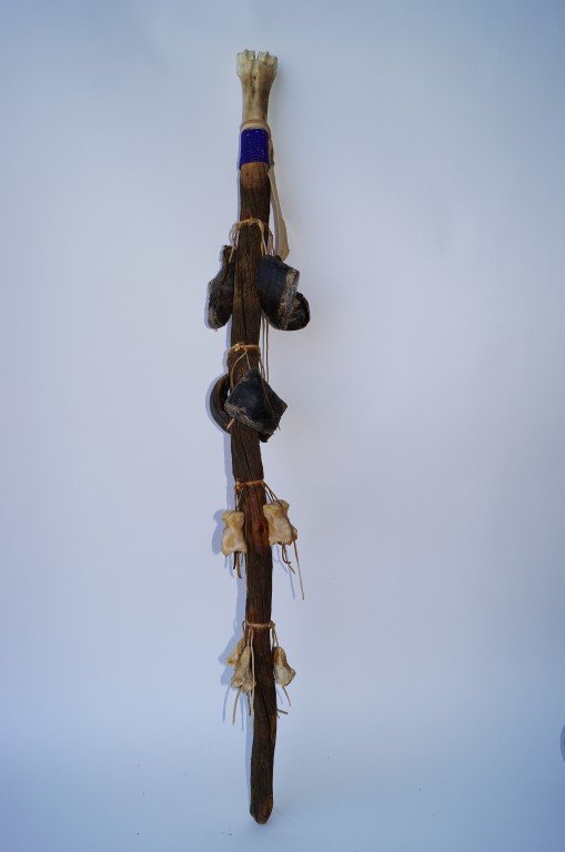 Siioux Sitting Bull Rattle: Buffalo leg bone with a grip of glass beads, buffalo hoof decorations with old trade beads 50"L.