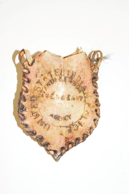Standing Rock Medicine Bag Badge: United States Indian Police Seargeant's medicine bag badge. Standing Rock. Large bear claw inside leather bag. 3-1/2" high