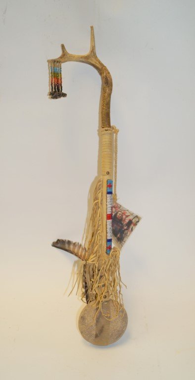 Native American Stone Club: Made by Dennis Eagle Horse. River rock, elk hide (brain tanned), seed beads, medicine bag, brass tacks, and bird feathers. 31" long