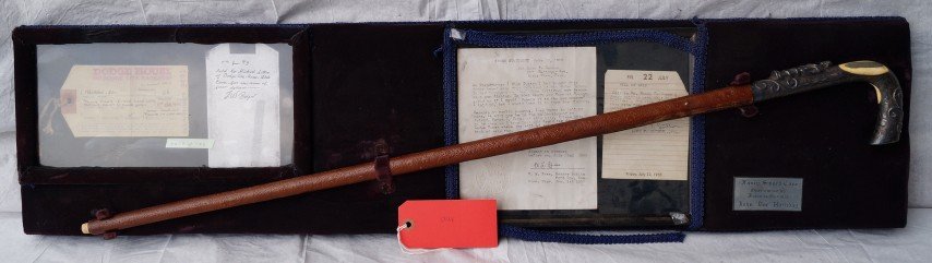 Doc Holliday Sword Cane: Leather shaft. Ornate silverplated handle with high relief figure. Ivory or bone inserts with plaque inscribed J. H. Holliday DDS. Mounted with a Dodge House, Dodge City Kanasas unclaimed property tag