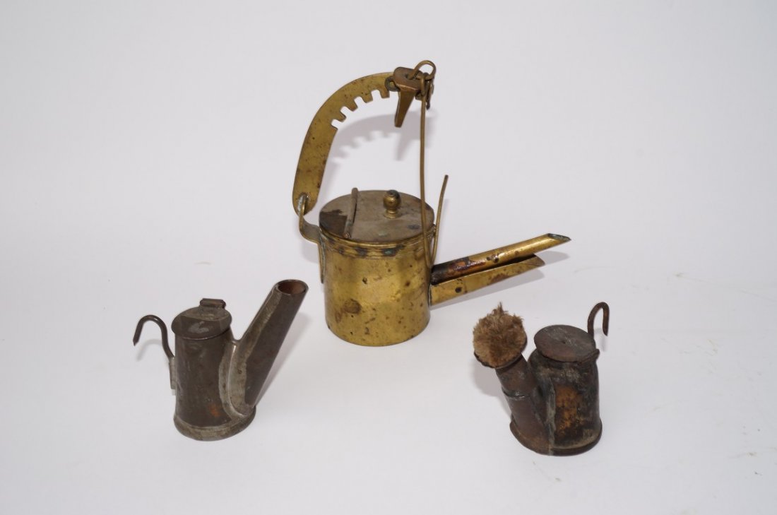 Three Early Lamps, Probably Miner's Lamps: One brass and two small wick lamps with hooks for attachment. 3" to 7" H.