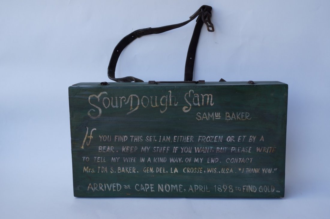 Samuel Baker's Alaska Gold Miner's Box: A gold miner's box from Alaska containing sealskin Eskimo slippers; a snow protecting hat made from beaver pelts; a tin cup; tins; a photo of the miner; a photo of the miner and his wife; postage fare