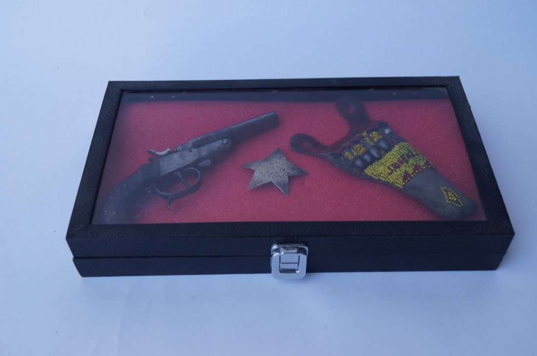 Double Barrel Pistol of John Baxter Hall: Double barrel pistol, suspender holster with beadwork and U.S.I.S. Agent badge of John Baxter Hall. (1852-1954). Hall worked on the Fort Hall Shoshoni Reservation in the 1880's and 1890's. In a displa