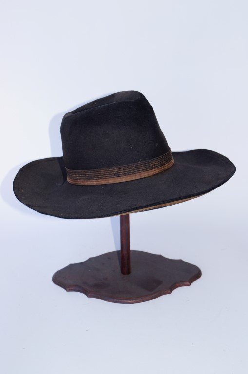 Western Cowboy Hat by Miller: High crowned, wide brim Western cowboy hat with original grosgrain ribbon. On stand.