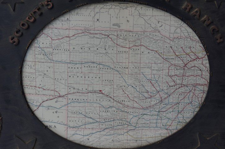 Map-Alaska Territories: Gessoed wood frame is decorated with stars. Raised lettering reads "Scouts Rest Stock Ranch, Co. W. F. Cody. 21.5" x 25.5 "