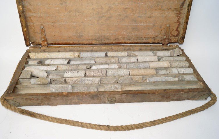 Wooden Ore Sample Core Box & Gold Crucibles: With sample rock cores, rope handle.; together with 4 Dixon Graphite Gold Crucibles. 31" l x 13" w; 5" h to 8" (crucibles)
