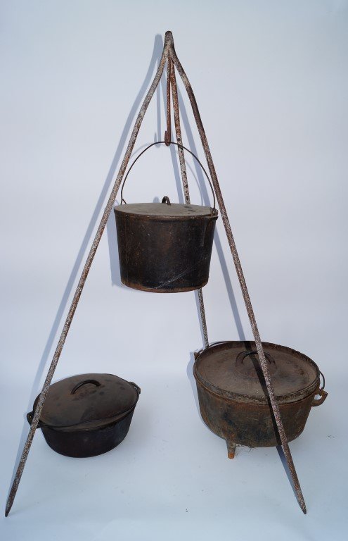 Cowboy On-The-Range Cook Set: Three cast iron pots with lids together with a three-legged wrought iron open oven stand. Stand measures 41" high; Pots measure 9-1/2"wide, 11-1/2" and 14".