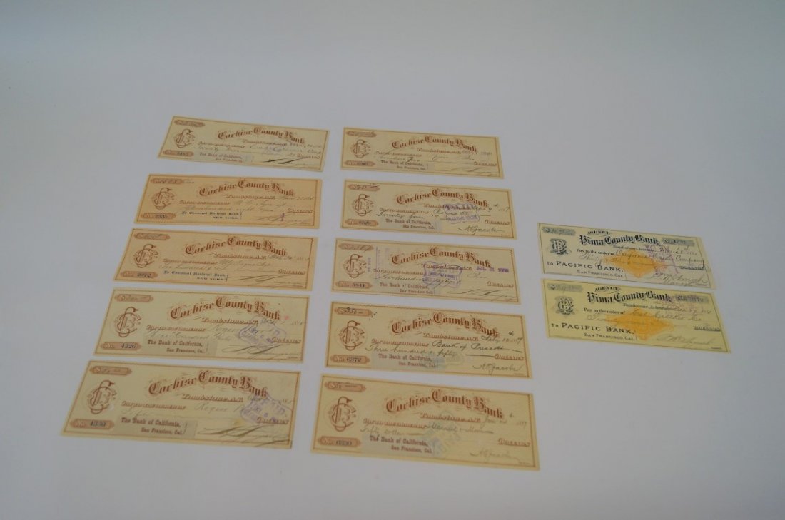 Twelve Tombstone Cochise Bank Checks: All drawn on Cochise County Bank, Tombstone, A.T.. Checks in 1881, 1885, 1886, 1887 and 1888. Different payees. Endorsed, some with Wells, Fargo & Co. stamps at back.