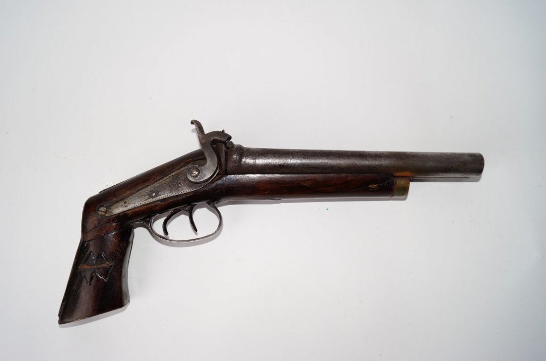 Manton Percussion Lock Gun: The Three Horsemen Gun. Side by side. 12 Gauge. Pistol Grip. 9 1/2" barrels Double trigger. . Brass end mount to the wooden handle having applied engraved silver mounts marked Manton. A high relief pl