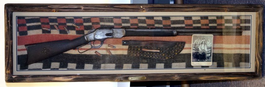 Winchester 1873 Rifle: Recovered near Wounded Knee, South Dakota. In a shadow box display by Chuck Gelisse. Included in the display is a knife in a tack decorated sheath, some cartridges and a cabine card of an Indian with 