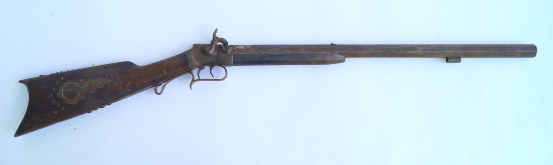 Percussion Rifle: 50 calibre. Octagonal barrel. Silver patch box. Brass tack surround. Gold fabric perhaps from epaulets decorate the stock. Iron fore end. No markings except E.REM. on side barrel flat