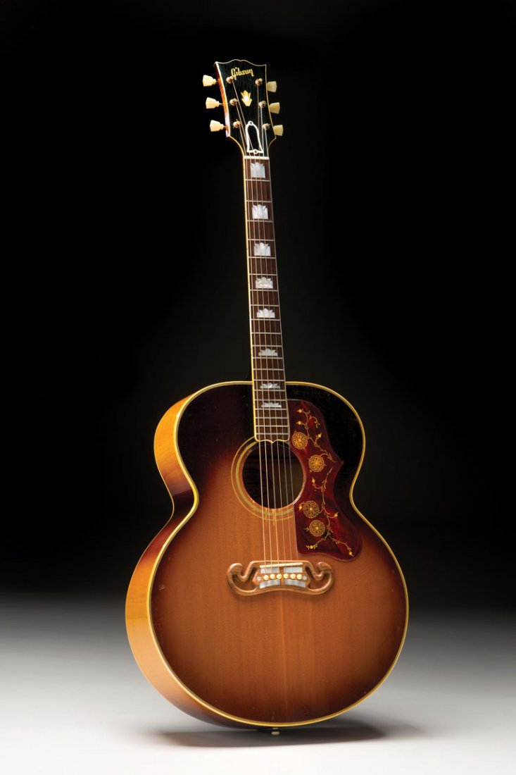 1958 Gibson J-200: NO RESERVE. The most striking feature of this 1958 Gibson J-200 is its unusual sunburst finish, which lacks the dark shading typically seen along the edges of the guit