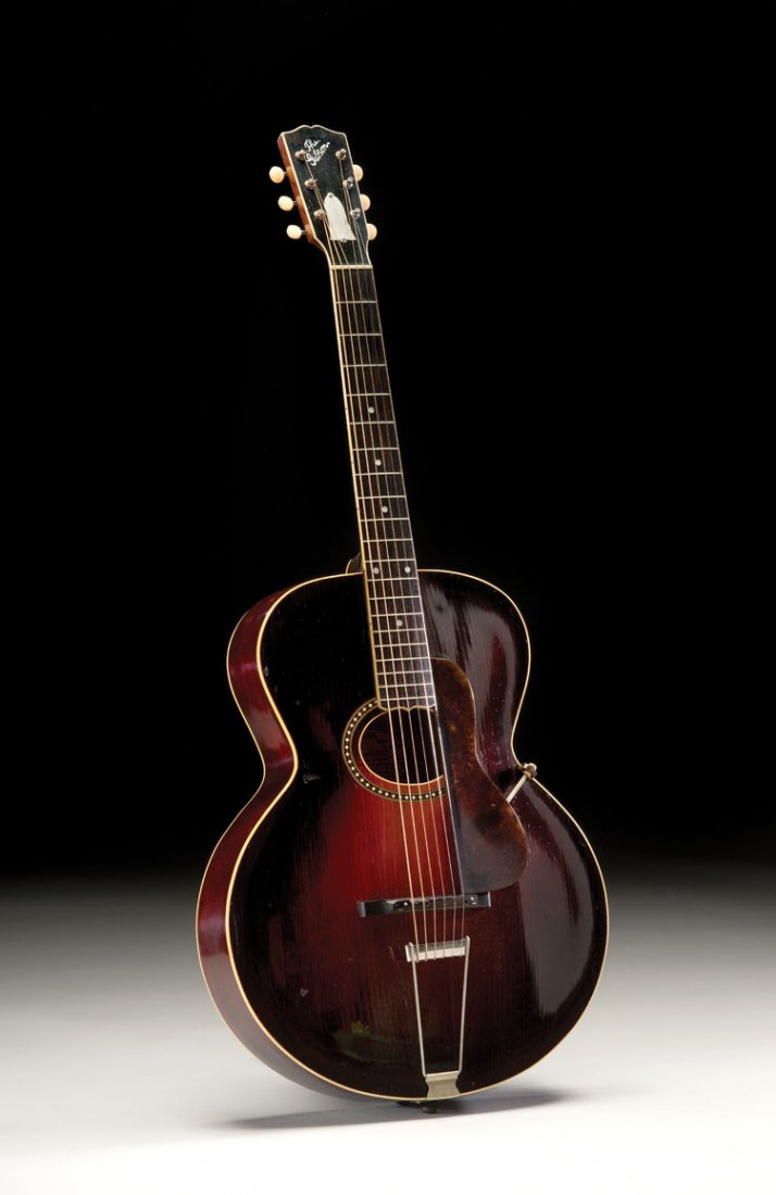 1923 Gibson L-4: NO RESERVE. In 1923, Gibson abandoned the pin trapeze bridge in favor of a standard design with a metal cross bar that anchored the strings. This 1923 L-4 also feature