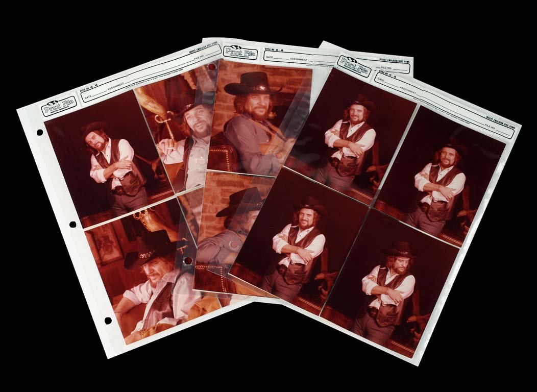Nine Contact Prints of Waylon in His Signature Outfit: Nine contact prints of Waylon in his signature look: black cowboy hat, shirt, and vest. Often photographed in his Brentwood, TN home, various antiques purchased by both Waylon and Jessi showcase their