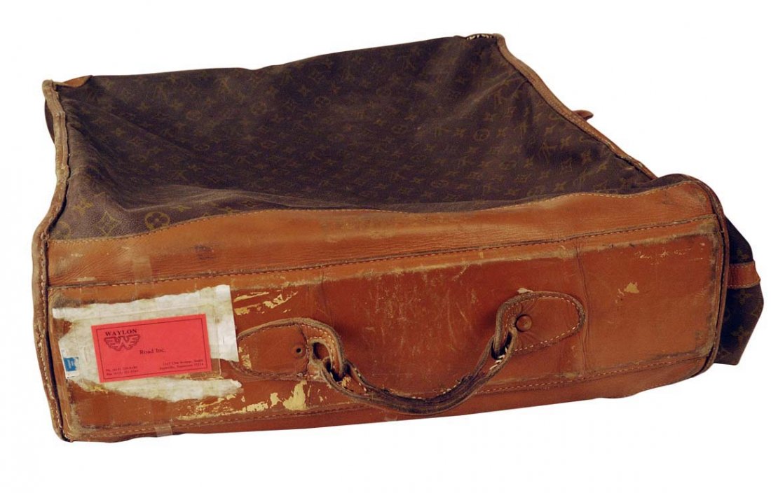 Louis Vuitton Luggage with Waylon's Road Inc. ID Card: Louis Vuitton luggage/garment bag with Waylon's Road Inc. ID card attached by clear tape. In well-worn condition. Used by Waylon on his extensive road trips with the touring company, Road Inc. This en