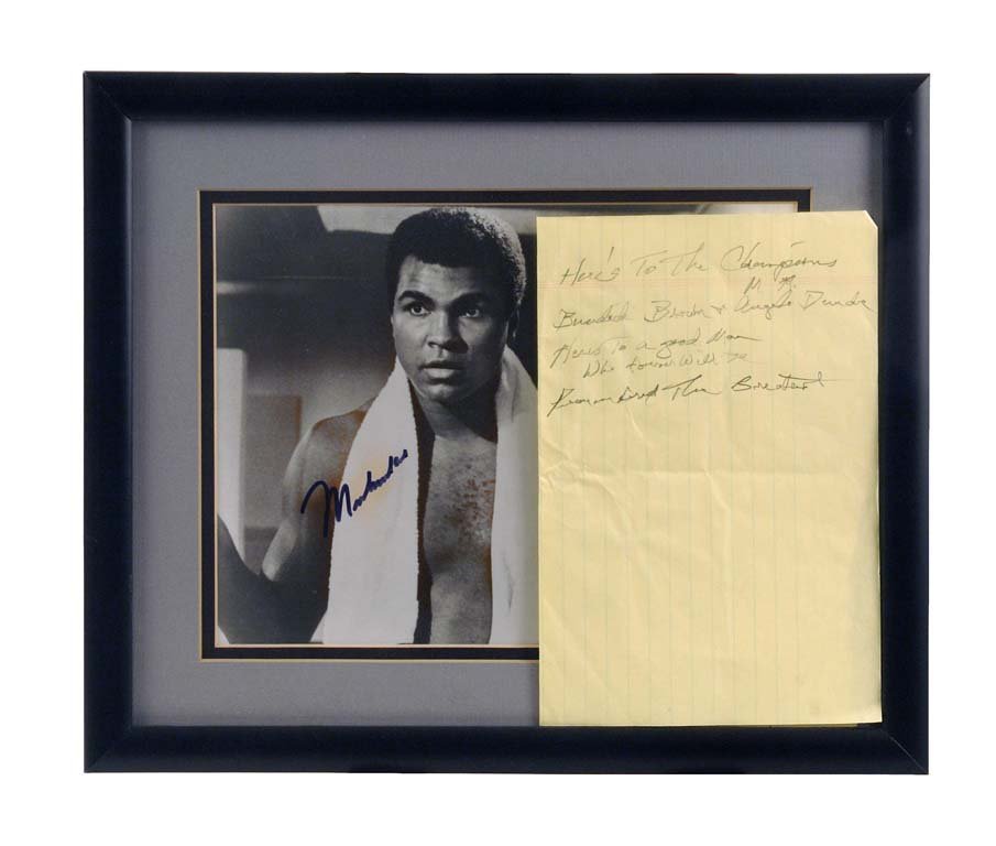 Autographed Photograph of Muhammad Ali with a Sheet of: Waylon Jennings' handwritten lyrics in honor of Muhammad Ali: “Here's to the champions / Bundini, Byron and Angelo Dundee / Here's to a good man / who forever will be / (remembered as) the greatest.
