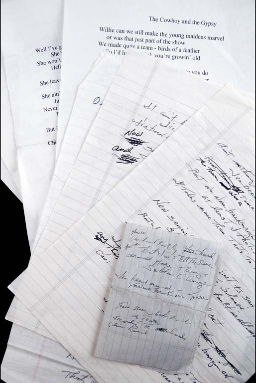 Collection of Handwritten and Printed Lyrics: A collection of four pages of handwritten lyrics by Waylon Jennings plus assorted printed lyrics of his music. One printed sheet has notes in Waylon's own hand. Handwritten lyrics include: “For The 