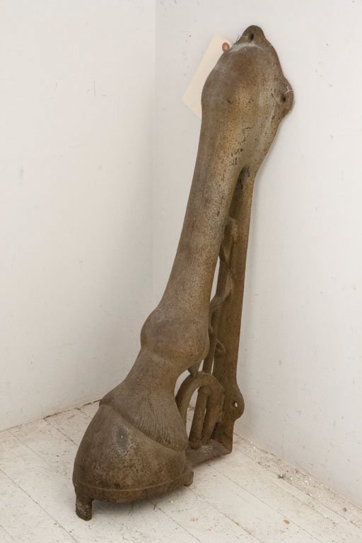 DECORATIVE HOOF STOPPER C. 1900: Taken from a West Village stable, this hoof stopper was originally used to protect the walls of the building from carriage wheels. The stopper features a cast iron horse hoof accompanied with a whip a