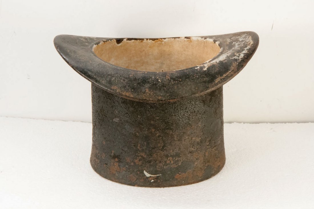 TOP HAT SPITTOON C. 1880: Spittoons were known to be used as far back as the 14th century. This cast iron spittoon shaped as a top hat may have been used in a place requiring more decorum, like an opera house. The interior is 
