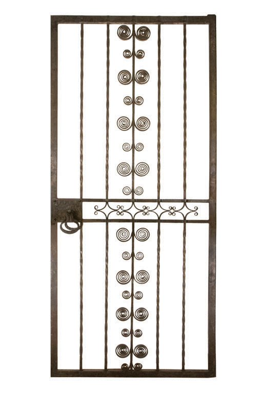 SAMUEL YELLIN DOORS, C. 1927: Each wrought iron door was built and designed by Samuel Yellin Metalworkers. The doors come in various styles and feature different hand-crafted doorknobs. American. 36" W x 85" H x 3/4" thick. Sizes 