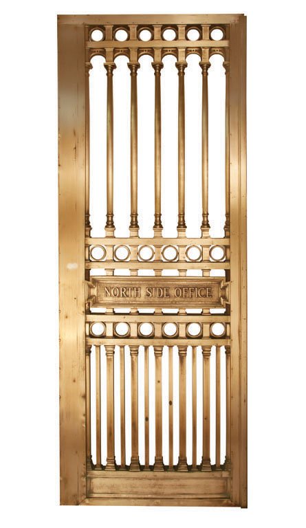 NORTH SIDE OFFICE BRASS DOOR: This brass door features a sign inscribed "NORTH SIDE OFFICE" and was taken from a New York City bank. The door's sign portray's the bank as a vault where one's valuables can be safely stored. H 98" x
