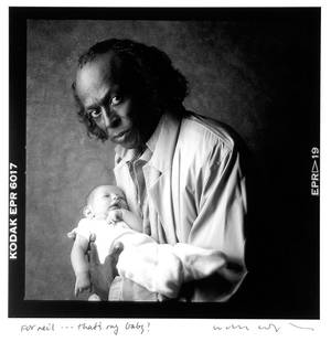 William Coupon (b. 1952): Note: Description Updated 11/23. Miles and Hayley. B&W, c. 1986. Pigment print. Printed later. Framed. Miles Davis, holding William Coupon's grandchild. Signed and inscribed in ink to Neil Leifer by p