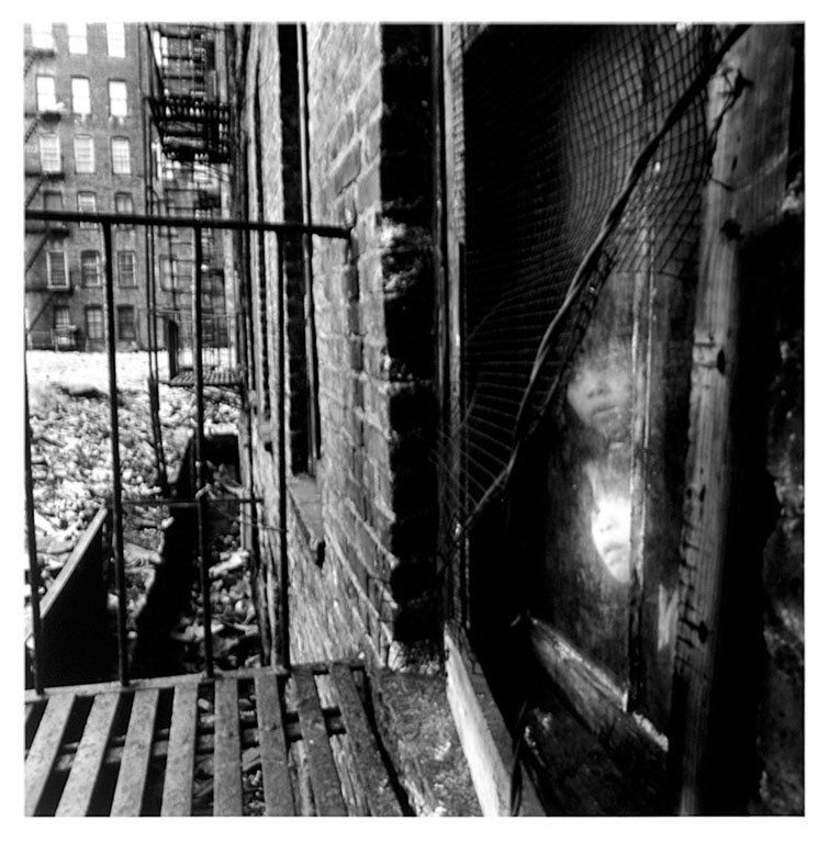 Bruce Davidson (b. 1933): Note: Description Updated 11/21. Children at Window. B&W, 1966-68. Fiber-based silver gelatin. Older print. View from a fire escape with two children looking through the window. Signed and numbered 59