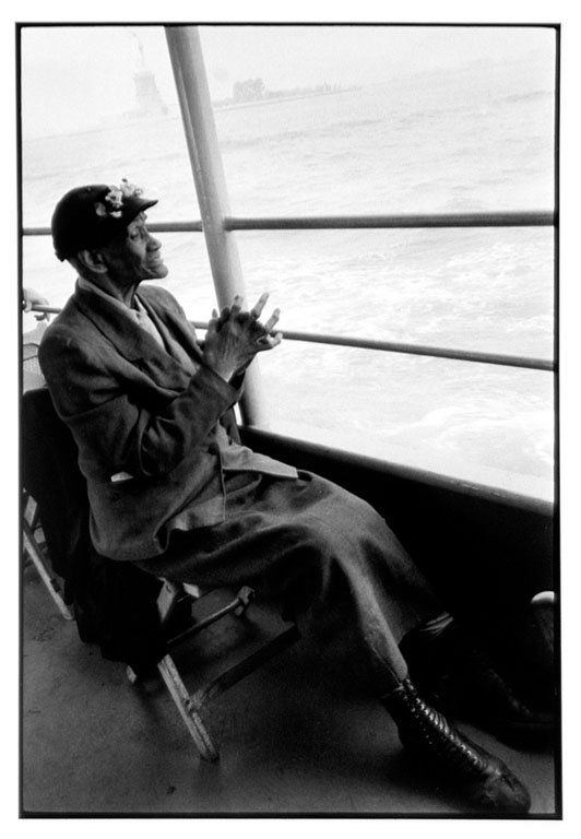 Bruce Davidson (b. 1933): Note: Description Updated 11/21. Elderly Woman, Staten Island Ferry. B&W, c. 1962. Fiber-based silver gelatin. The 110-year-old Mother Brown sitting on the Staten Island Ferry with a misty Statue of L