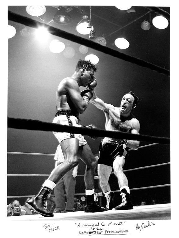 Hy Peskin (1915-2005): Note: Description Updated 11/22. Sugar Ray Robinson vs. Carmen Basilio. B&W, c. 1957. Fiber-based silver gelatin. Older print. Sugar Ray Robinson fighting Carmen Basilio. Basilio's injury served as th